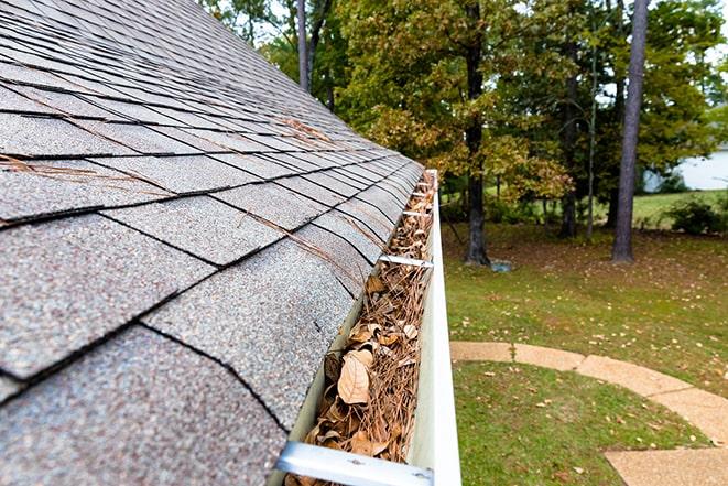 removing dirt and leaves from residential gutters